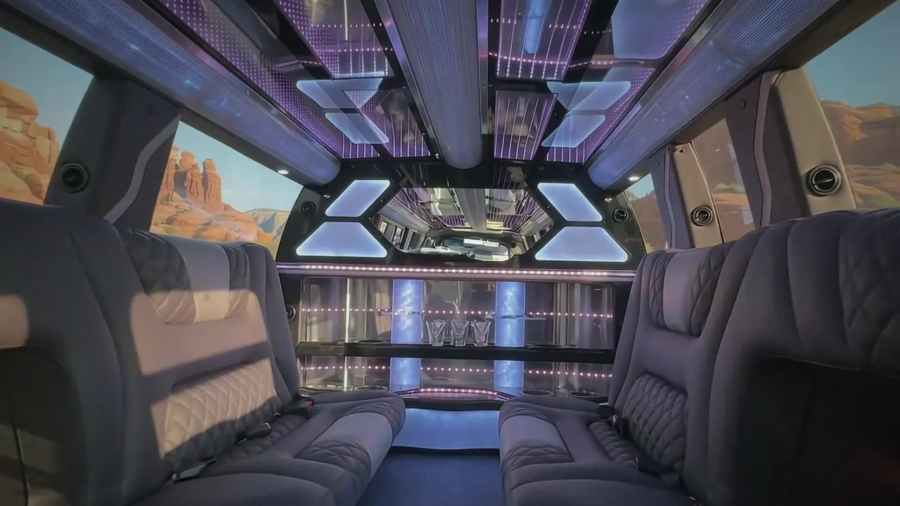 Inside the Cadillac Escalade limo in Breckenridge Colorado: LED light-show ceiling, leather lounge seating and lit bar